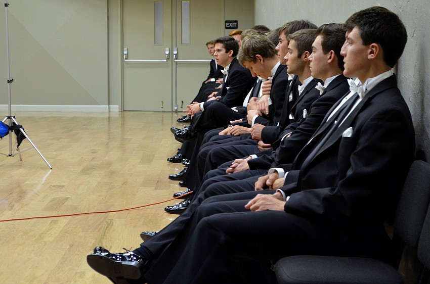 The escorts patiently wait as the debutantes take photos.