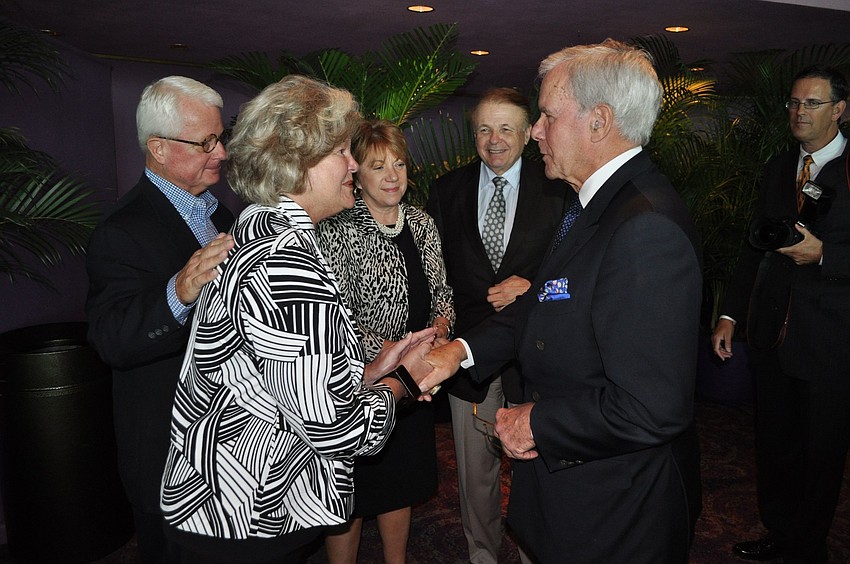 Sally Sharp shakes hands with Tom Brokaw.