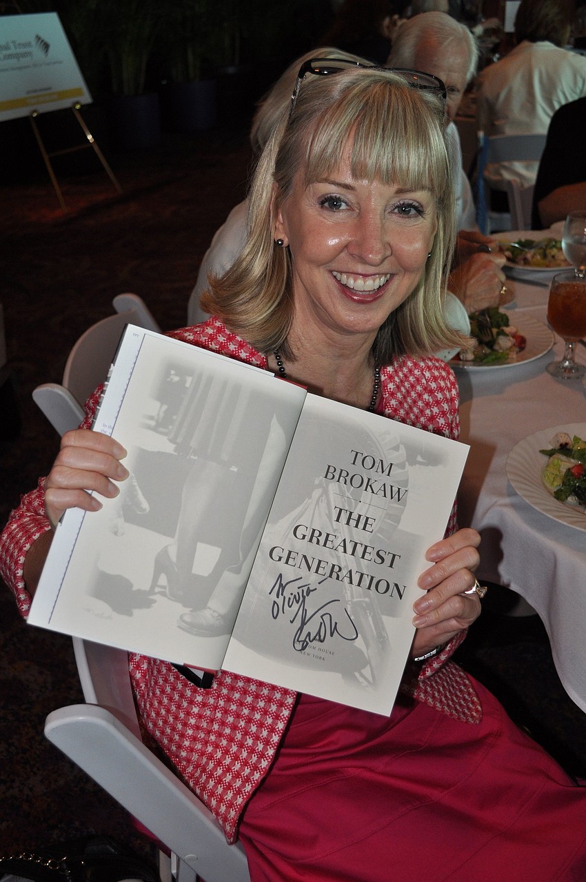 Olivia Thomas shows off her signed copy of  â€œThe Greatest Generationâ€ by Tom Brokaw.