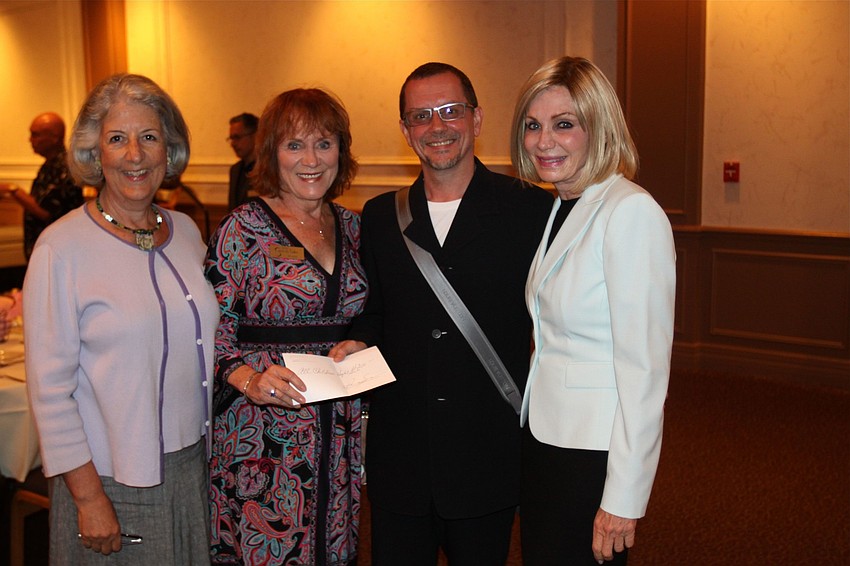 Lydia Landa and Kay Aidlin were given a check from Iain Webb and Hillary Steele for $4,200 for All Childrenâ€™s Hospital.