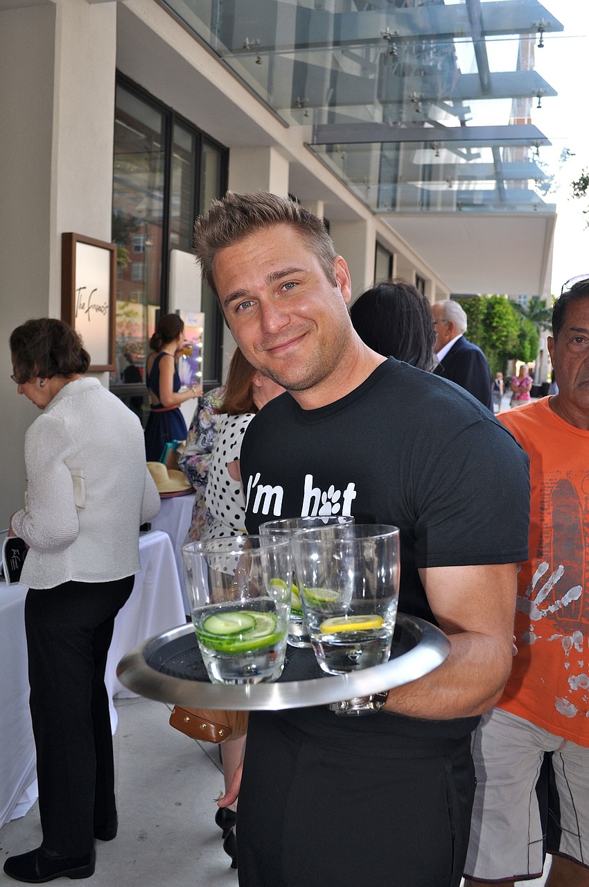 Larry Bowman wore an â€œIâ€™m Hotâ€ Humane Society of Sarasota County shirt while helping to pass out drinks Friday afternoon.