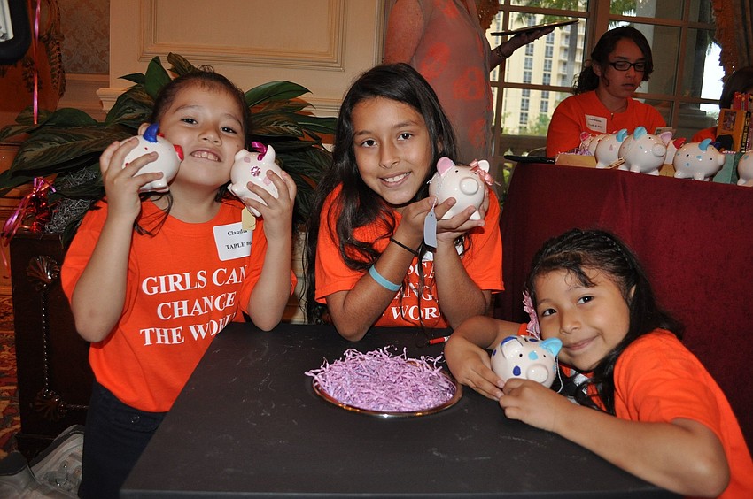 Claudia, Zuleima and Michelle with decorated piggy banks