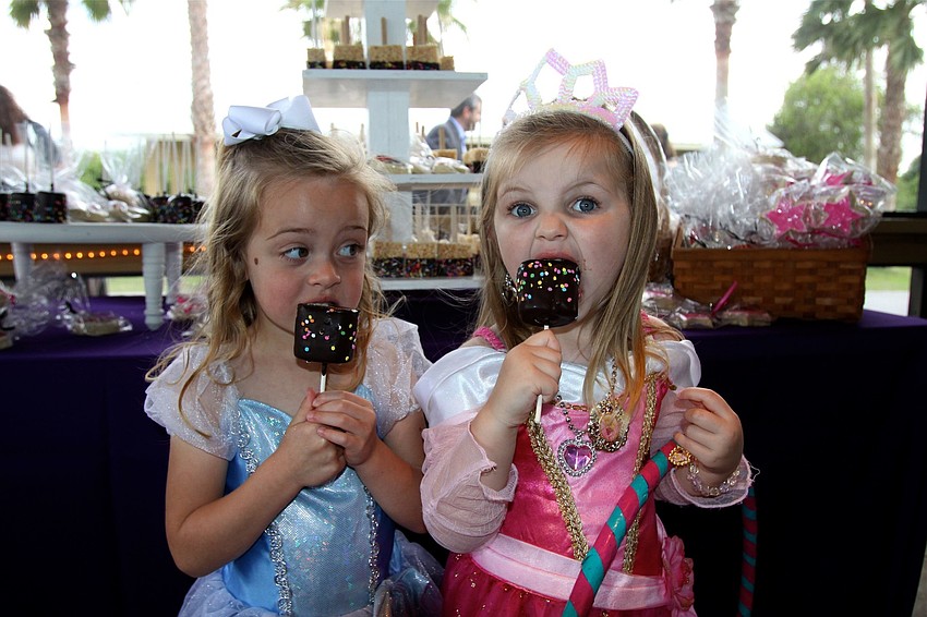 Avery Hunt, 3 Â½, and Olivia Gambert, 3, have fun eating marshmallow treats before dinner.