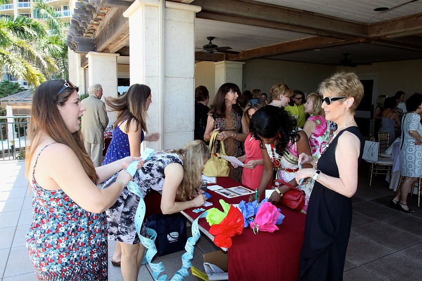 Guests signed in and bought raffle tickets.