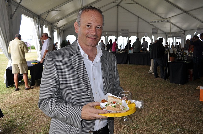 Michael Grant shows off his plate with crab fritters and a shrimp poâ€™ boy sandwich.