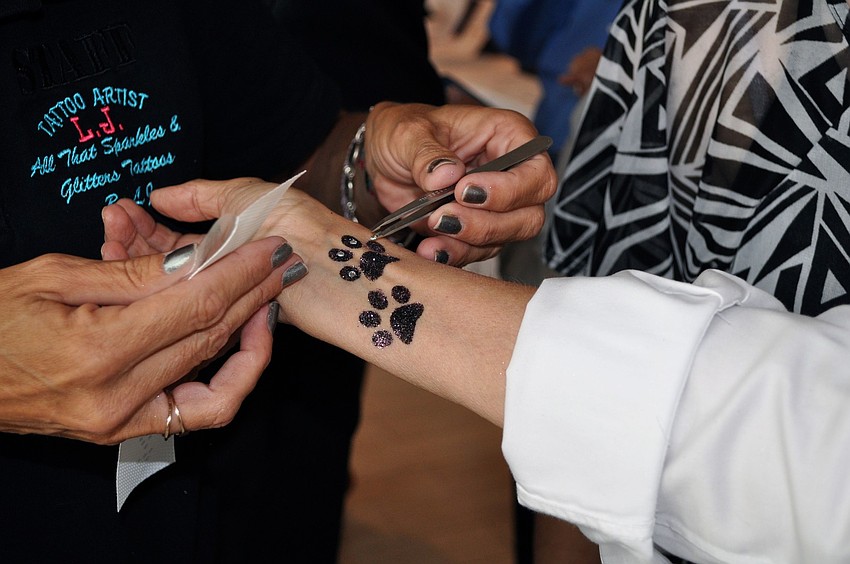 Janet Rice gets paws temporarily tattooed on her wrist.