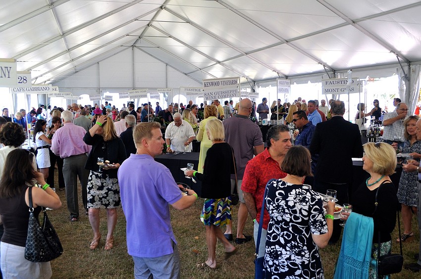 People wandered underneath the tent trying different wines and food from local restaurants.