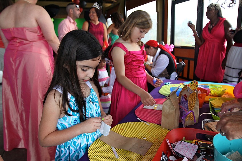 Mia LaPorta, 6, and Blaire Yahraus, 9, work on a craft project.