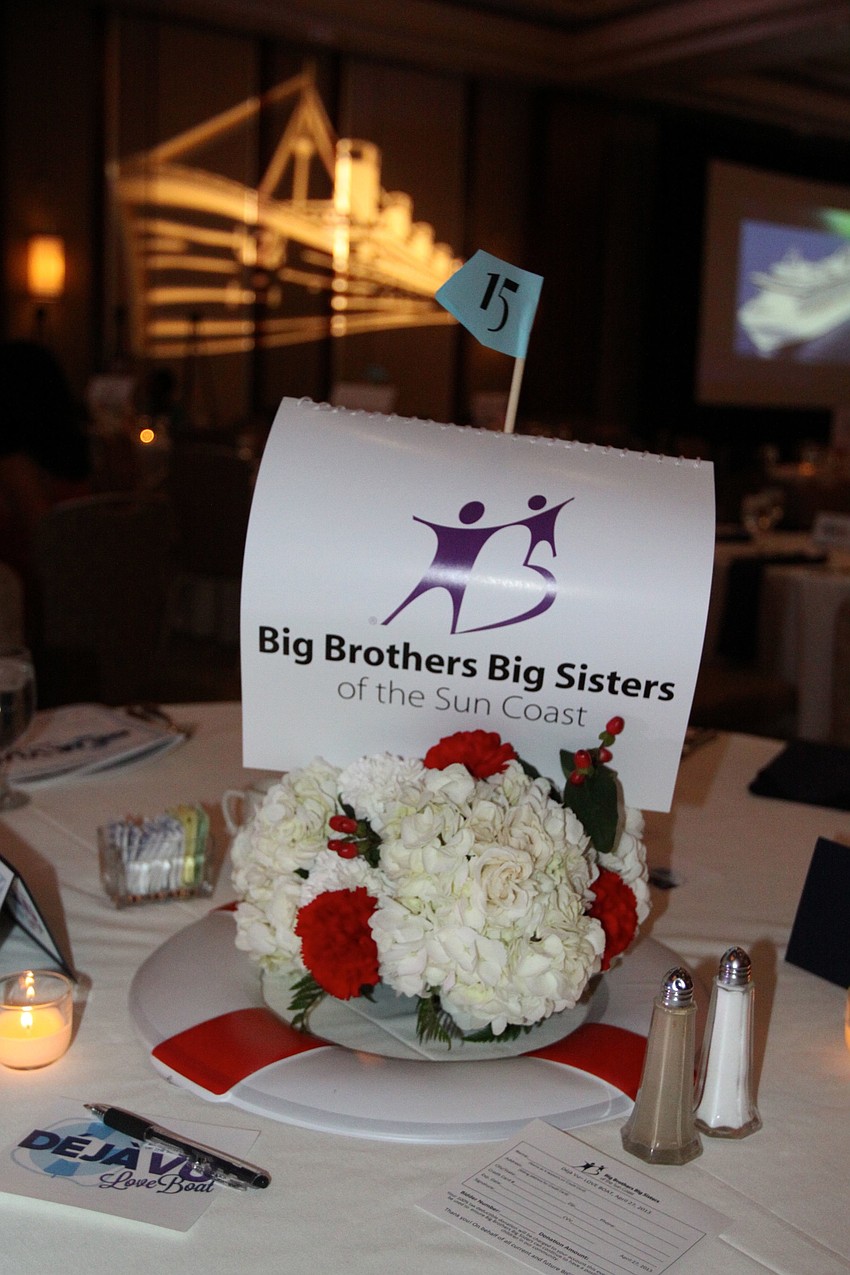 Each table had a life preserve with a Big Brothers Big Sisters of the Suncoast sign in the center along with red and white flowers.