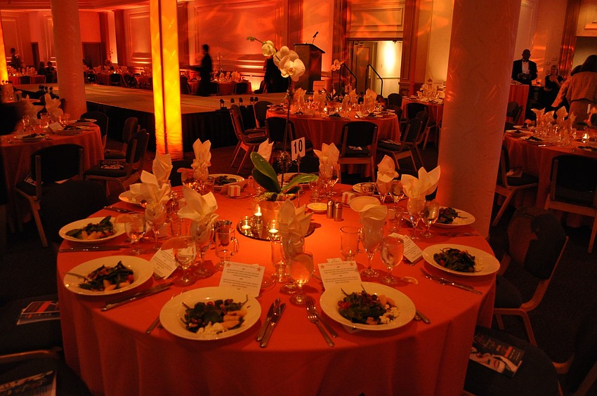 The tables had beautiful orchids as the centerpieces and the room was flooded with orange lighting.