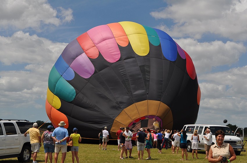 People watch as one of the hot air balloons is blown up.