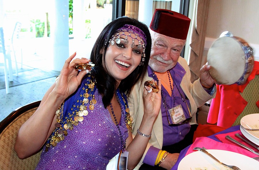 Yara Shoemaker and Bob Bartner have fun making noise at their table.