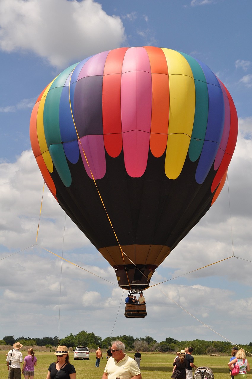 One of the hot air balloons was tethered and lifted off the ground during Sundayâ€™s Sip and Soar event.