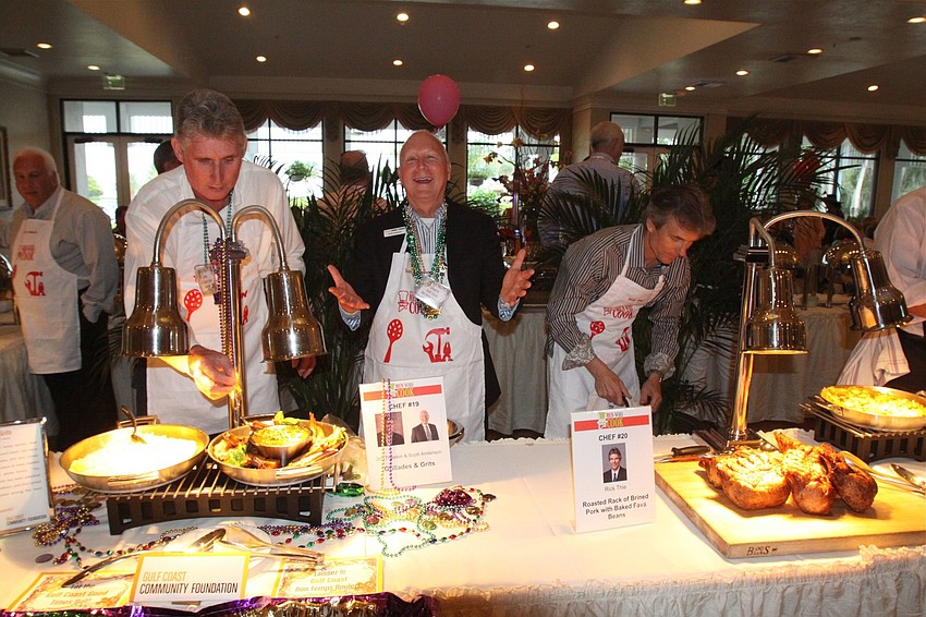 Jon Thaxton, Scott Anderson and Rick Thie get their food ready to serve.