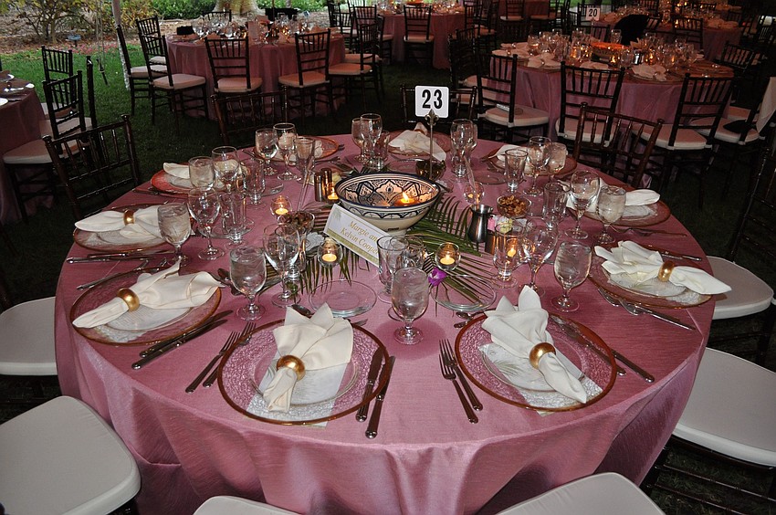 The tables were decorated with pink tablecloths and centerpiece featuring floating candles and flowers.