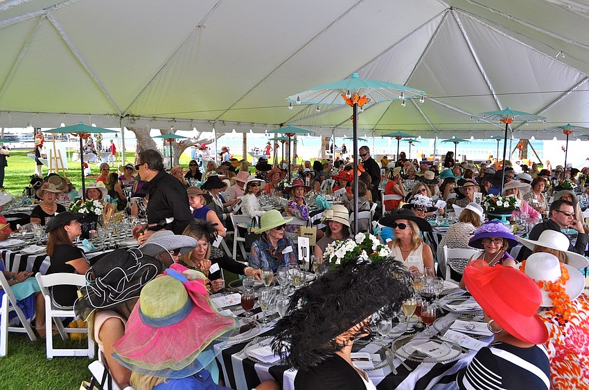 The women sat underneath tents to stay cool during the fashion show and luncheon.