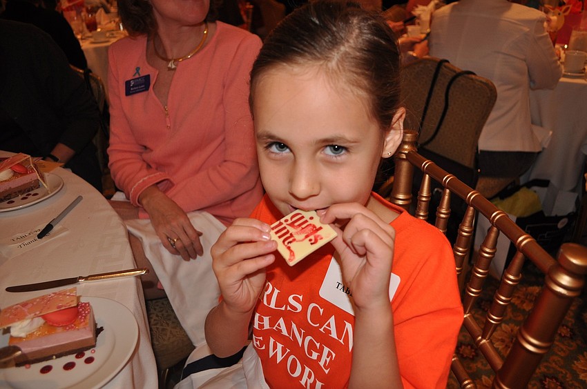 Kayla tries a taste of white chocolate.