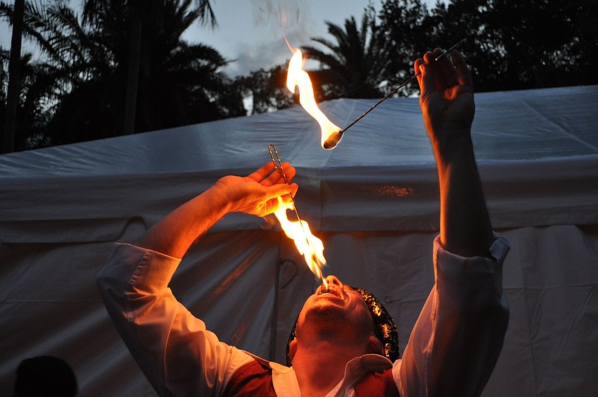Fritz Brothers eats fire as guests head to their tables.