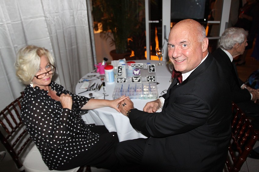 David Yarletts has a black, butterfly tattoo put on his hand by Libby St. Martin.