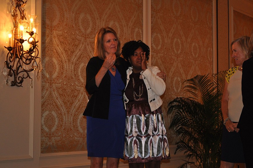 Dr. Myra McPherson comforts Shakeyla Dozier, Sandersâ€™ mom, while Sanders talked about how inspirational her mother and grandmother have been in her life.