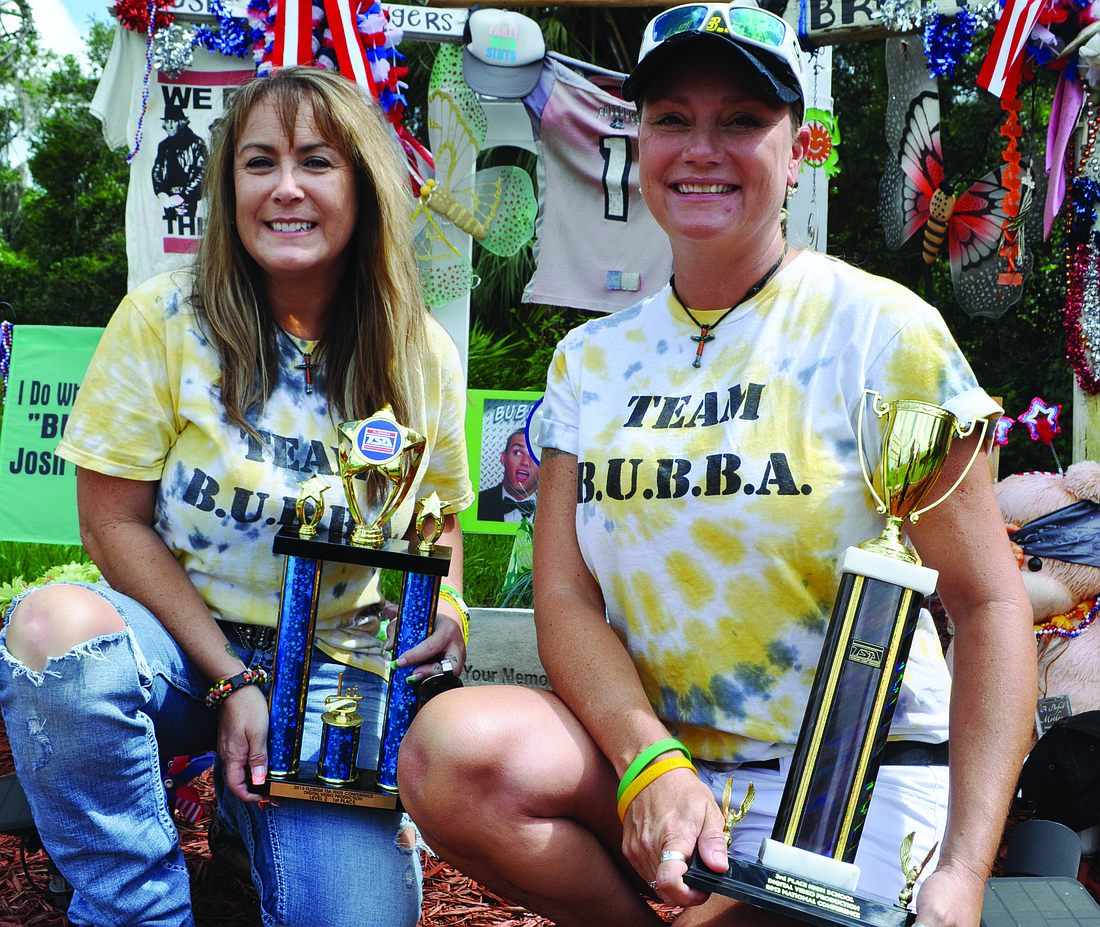 Debbie Wagner and Gena Rogers accepted state- and national-award trophies from students from Braden River High School July 5.