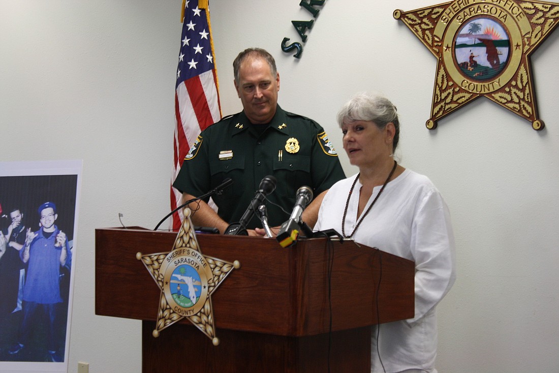 Sarasota County Sheriff Tom Knight looks on as Marylou Anderson, Taian "Andrew" Tian's girlfriend, speaks about the restaurant manager's tragic death.