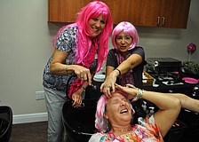 Monica Rice and Bobbie Sparks clean up friend, Linda Pretyka.