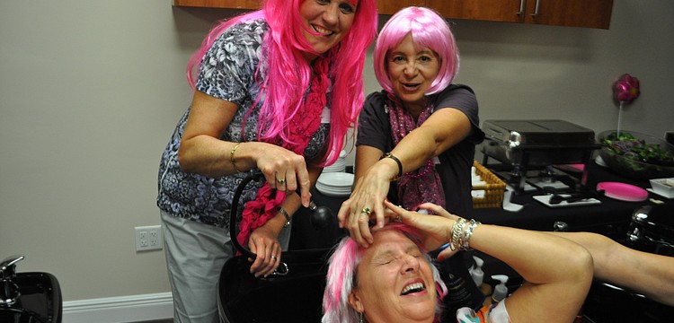 Monica Rice and Bobbie Sparks clean up friend, Linda Pretyka.