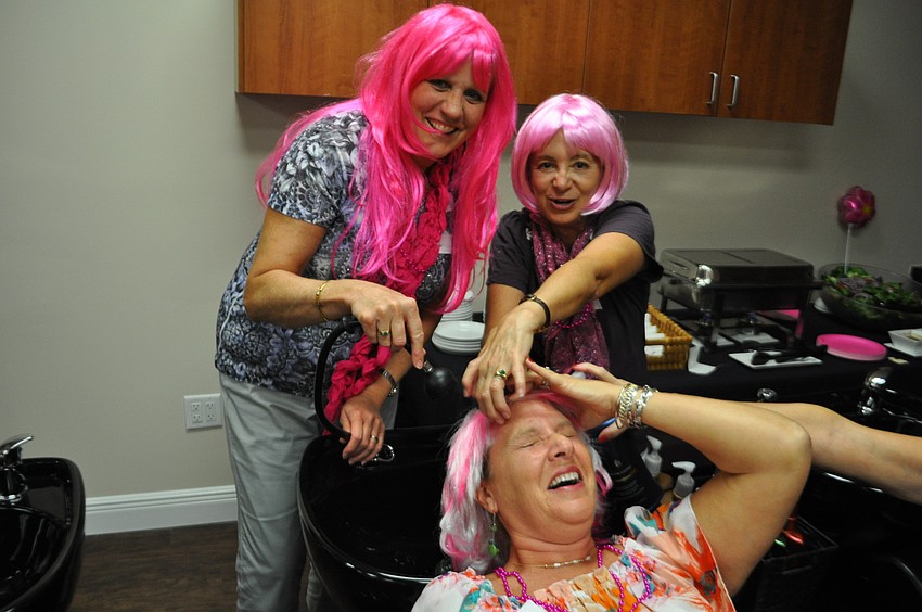 Monica Rice and Bobbie Sparks clean up friend, Linda Pretyka.