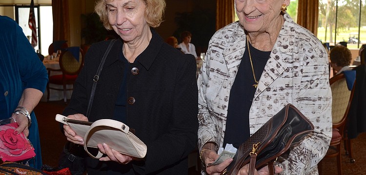 Gal pals Elizabeth Alee and Alyce Shaw browse their hand bag options.