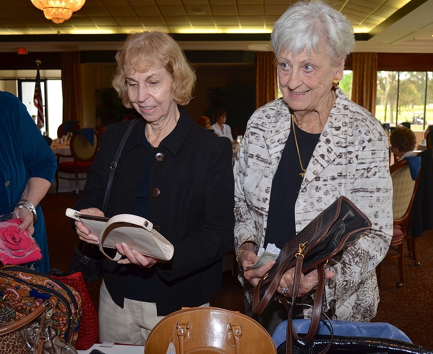 Gal pals Elizabeth Alee and Alyce Shaw browse their hand bag options.