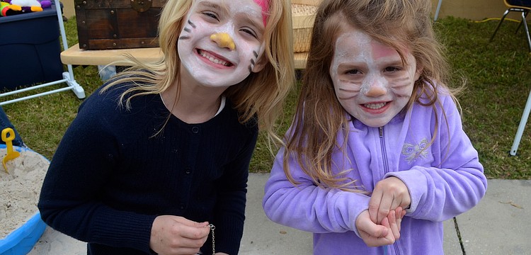 Cunningham sisters â€” Morgan, 6, and Samantha, 5 â€” show off matching Hello Kitty face paint.