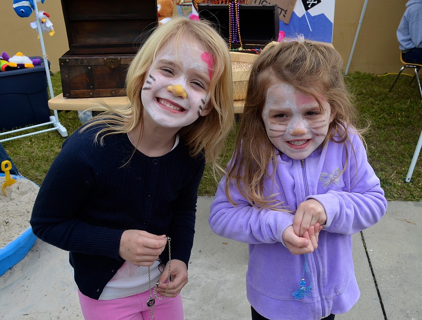 Cunningham sisters â€” Morgan, 6, and Samantha, 5 â€” show off matching Hello Kitty face paint.