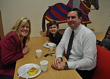 Monica, Ty, 7, and Kevin Moore feast on a pancake breakfast at Tara Elementary School. The event awarded Tara's 90 students who earned straight A's. Principal Steve Royce even cooked the pancakes.