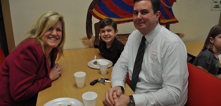 Monica, Ty, 7, and Kevin Moore feast on a pancake breakfast at Tara Elementary School. The event awarded Tara's 90 students who earned straight A's. Principal Steve Royce even cooked the pancakes.