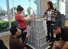 Tim Borden, Dana Haise, Brianne Allen and Scott Gross work on their can creation of the Empire State Building.