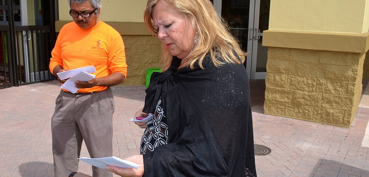 Cristi Valentine reads over a clue to determine the next stop on the hunt.