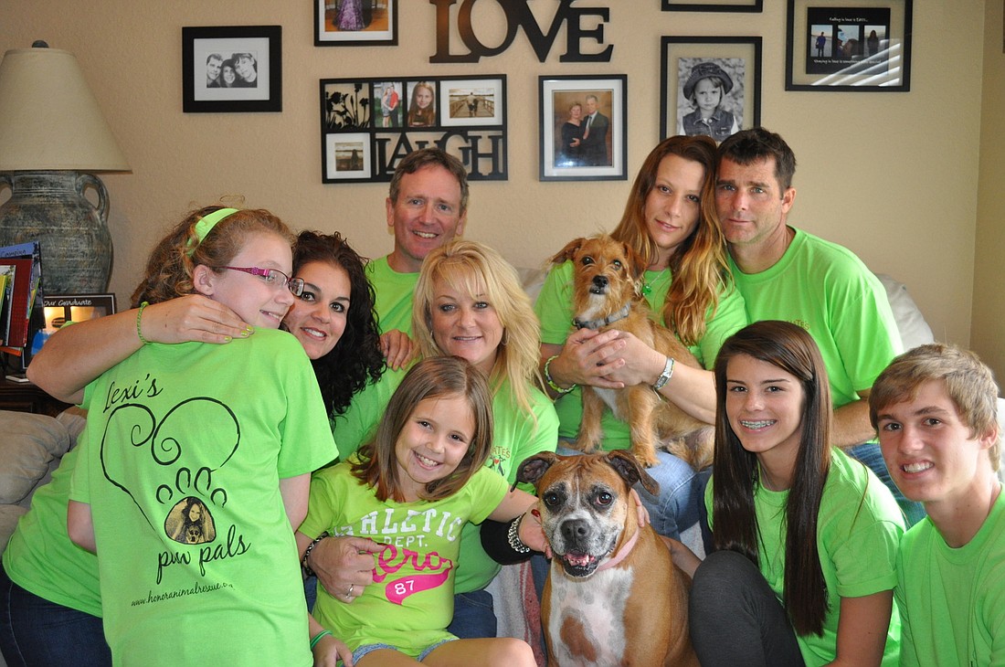 Lexi's family and friends wear lime-green shirts with "Lexi's Paw Pals" written in cursive on the back, to recognize a program at Nate's Honor Animal Rescue named in her honor.