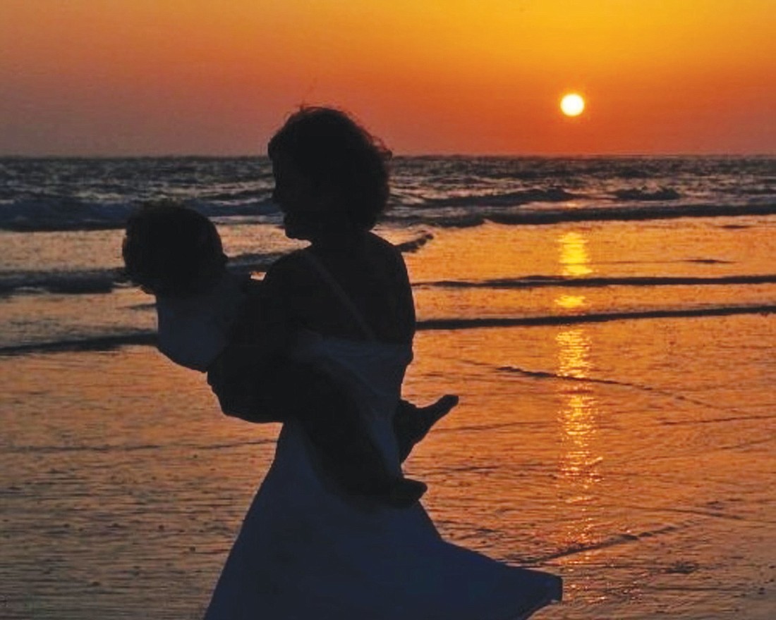 East County resident Paddi Juliano submitted this photo of herself holding her son during sunset at Siesta Key.