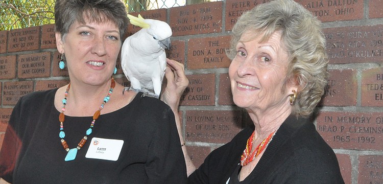 Lynn Lotsey and Bev Meadows with Kelly the cockatoo
