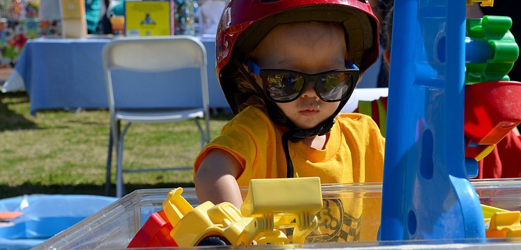 Jack Johnson plays in the toy bin.