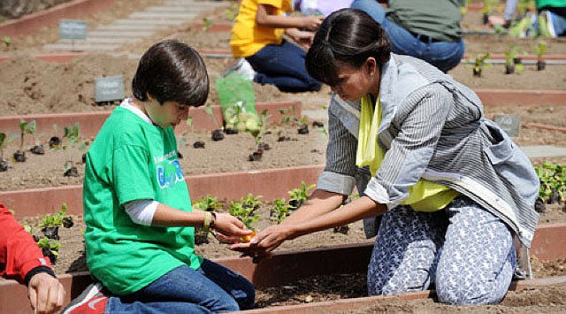 Emilio Vega, an 11-year-old Gullett Elementary School student from Colombia, was one of two students to be chosen randomly to work side-by-side with first lady Michelle Obama, as she planted a garden at the White House. Courtesy photos.