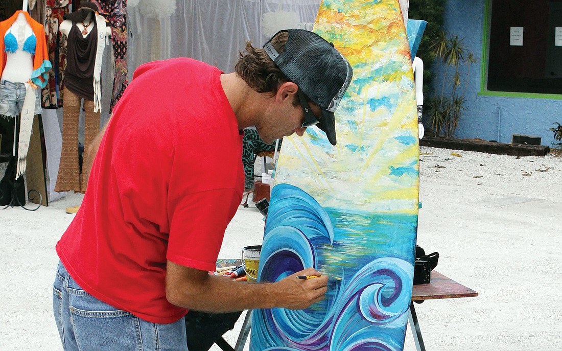Chad Ruis worked on a piece of artwork during the Siesta Fiesta festival last year.