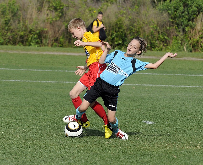 Strictly Soccerâ€™s Nikola Sljivic, 11, battles a Lakewood Ranch Chargers defender for the ball.