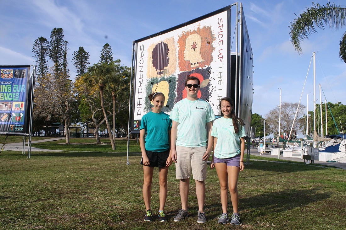 Colleen Manning, Matt Battles and Chelsea Meric in front of one of 39 billboard-sized pieces of artwork promoting a vibrant and inclusive community for every person. Mallory Gnaegy