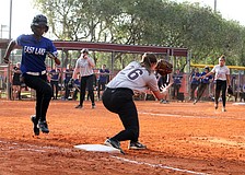 Riverviewâ€™s Taylor Johnson, 26, tags out East Lakeâ€™s Aliyah Andrews, 11.