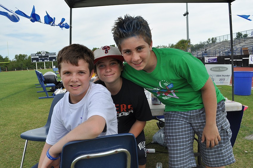Out-of-Door sixth graders Anthony Squitieri, Max Hajduk and Ethan Marino, who sold glow sticks at the race.