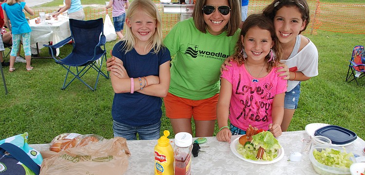 Olivia Heath and Simone, Natalia, and Cibele Urbanksi make hotdogs for the Kids Hotdog Cook-Off.