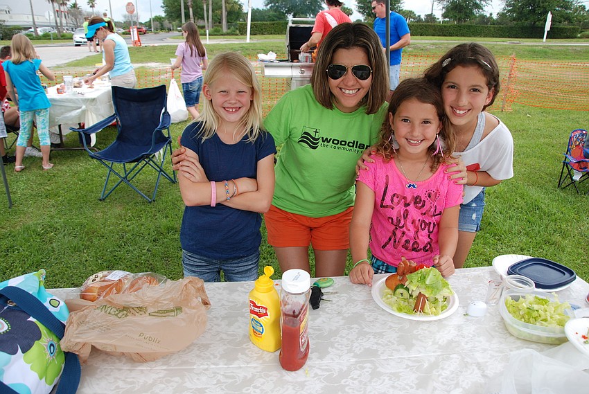 Olivia Heath and Simone, Natalia, and Cibele Urbanksi make hotdogs for the Kids Hotdog Cook-Off.