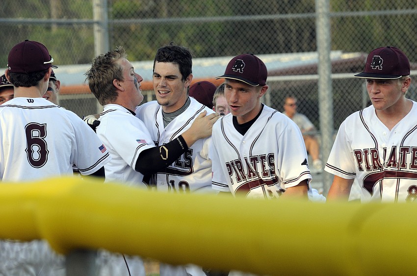 Braden River senior Dylan Lee, center, is congratulated following his solo home run in the bottom of the first inning.